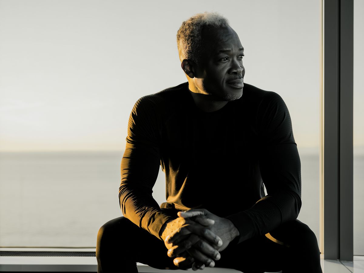 A calm man seated by a window